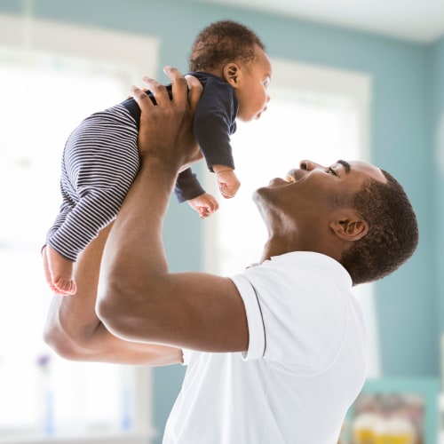 A father holding his son at Admiral Hartman in San Diego, California