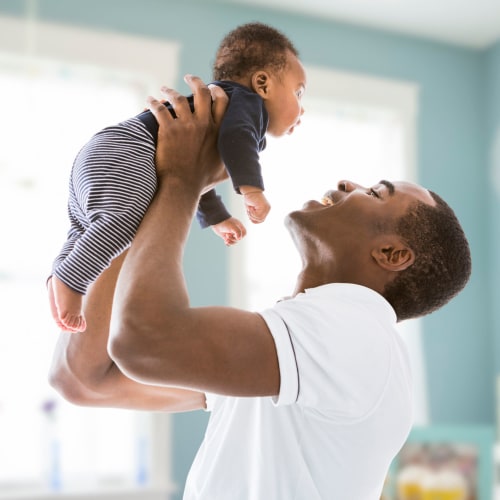 A father holding his son at Norwich Manor in Norfolk, Virginia