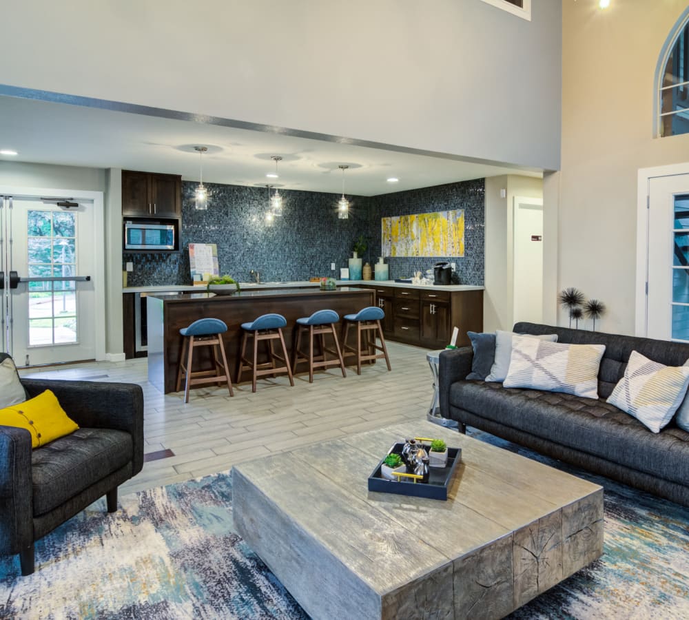 Model home's living area with plush carpeting and a fireplace at Sofi Lake Oswego in Lake Oswego, Oregon