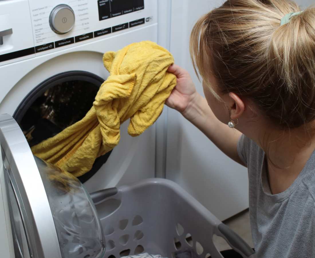 Resident unloading clothes from washing machine at Prospera at Homestead in Dixon, California