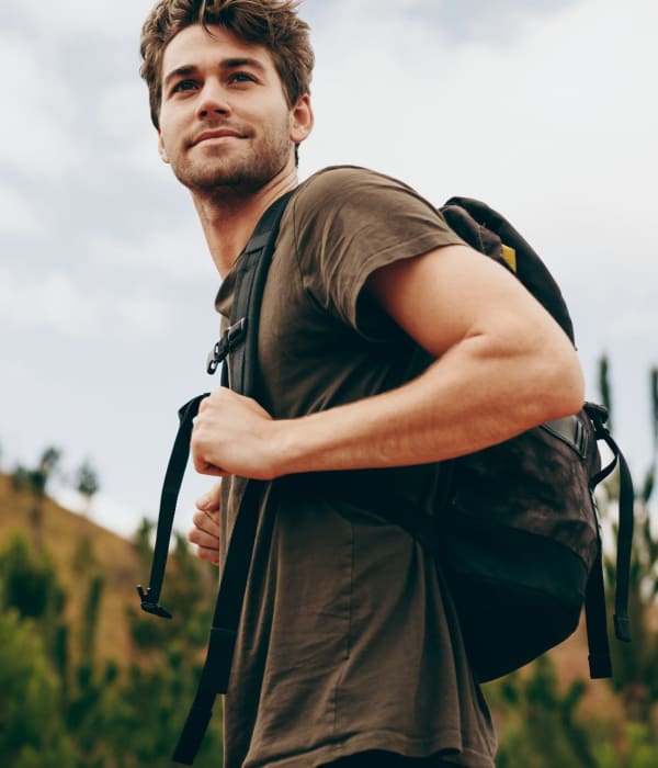 A man with a backpack hiking near A-AAAKey - WW White Rd in San Antonio, Texas A-AAAKey - WW White Rd in San Antonio, Texas