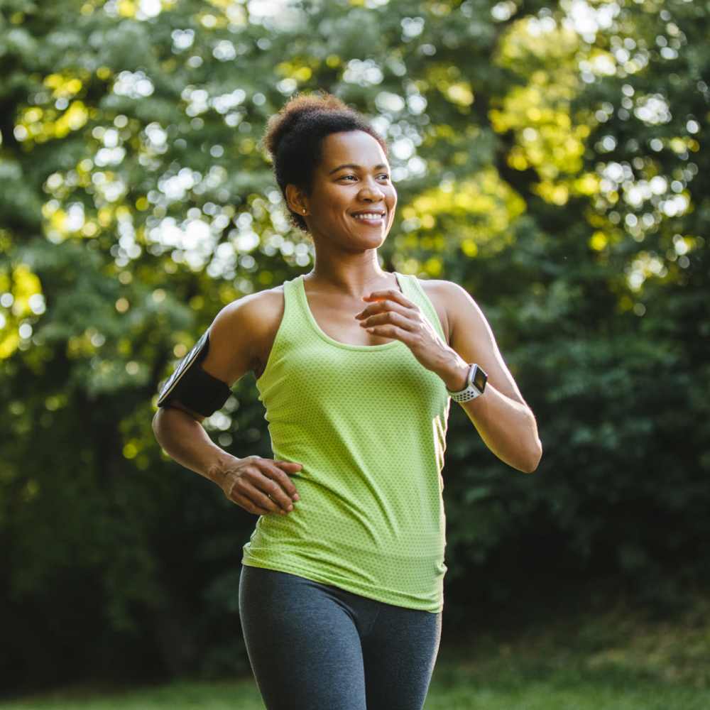 Resident woman jogging in park near Olivers Trace Apartments in Winston Salem, North Carolina