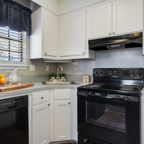 Black appliances and white cupboards in a kitchen at Vesta Creeks Run in North Charleston, South Carolina