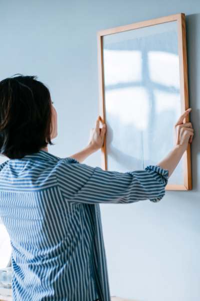 Resident hanging art at Wilhoit Properties, Inc. in Springfield, Missouri