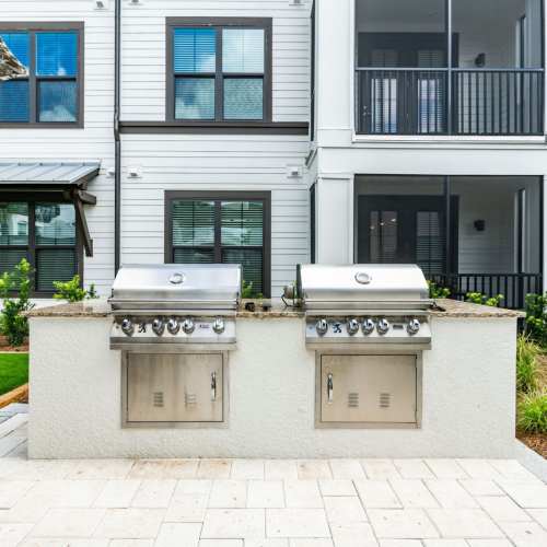 Poolside grill area with built-in barbecue stations at Brisa at St. Augustine in St. Augustine, Florida