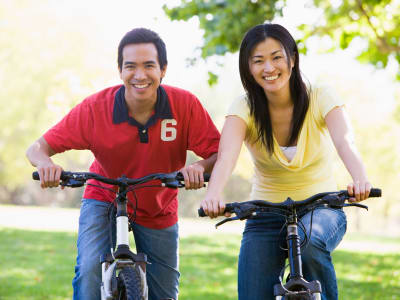 Couple riding bikes near Liberty Point Townhome Apartments in Draper, Utah