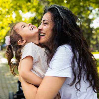 Woman playing with kid at park near Greentree in Indianapolis, Indiana
