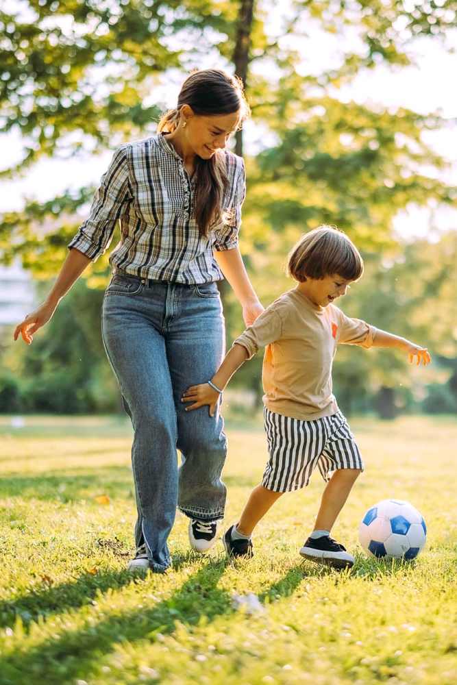 Resident with her kid playing at a park near The Trail Lakes in Fort Worth, Texas