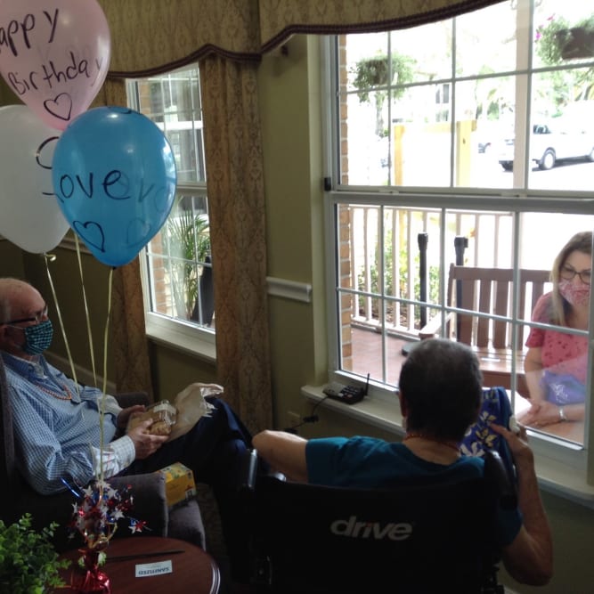 Residents meeting with family members while maintaining safe distances