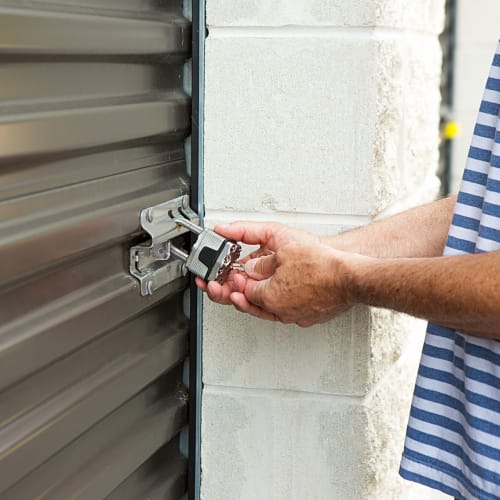 A man unlocking his unit at a San Marcos Mini Storage location