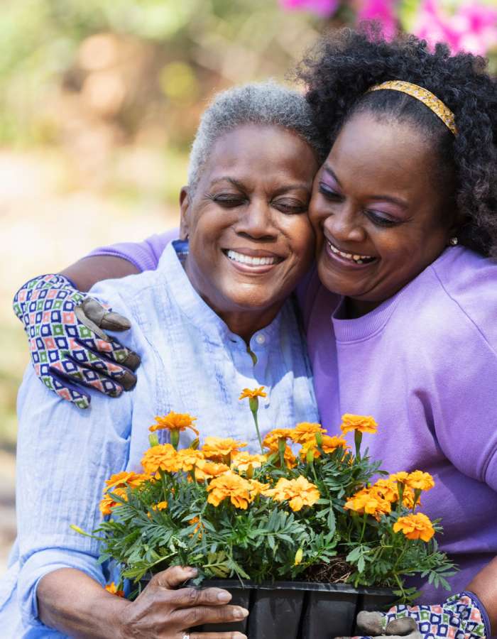 residents planting flowers in a pot at Clearwater at The Arboretum in Austin, Texas