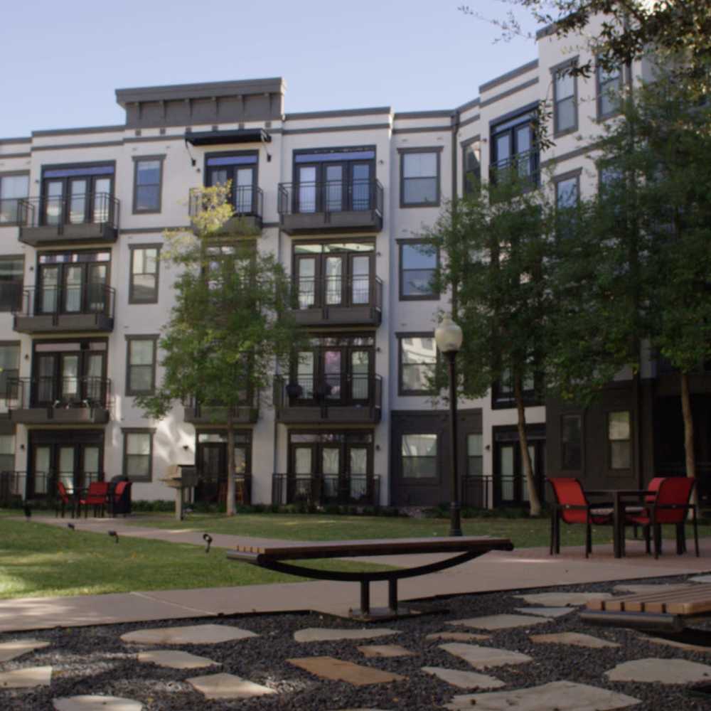 Seating area with lush green trees at Trinity Bluff & Trinity District in Fort Worth, Texas