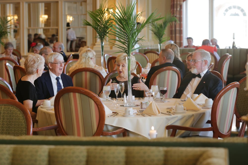 A group of residents seated together in the dining room at The Chamberlin in Hampton, Virginia