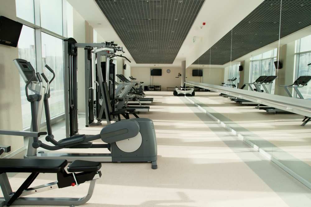 Fully equipped fitness center with treadmills, weight machine and flat screen television at Terraces at the Summit in Sherman Oaks, California