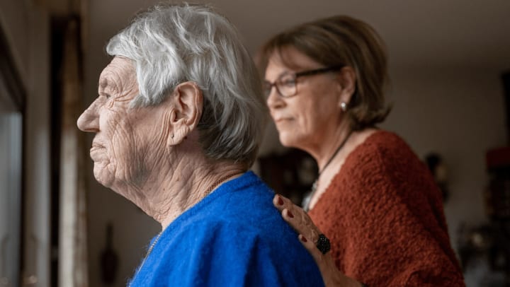 a senior lady and her daughter hugging each other