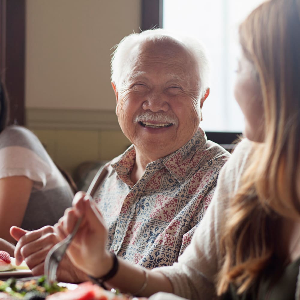 A smiling resident enjoying a health meal at Alder Bay Assisted Living in Eureka, California