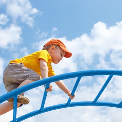 a young boy playing on a playground at Beachwood North in Joint Base Lewis McChord, Washington