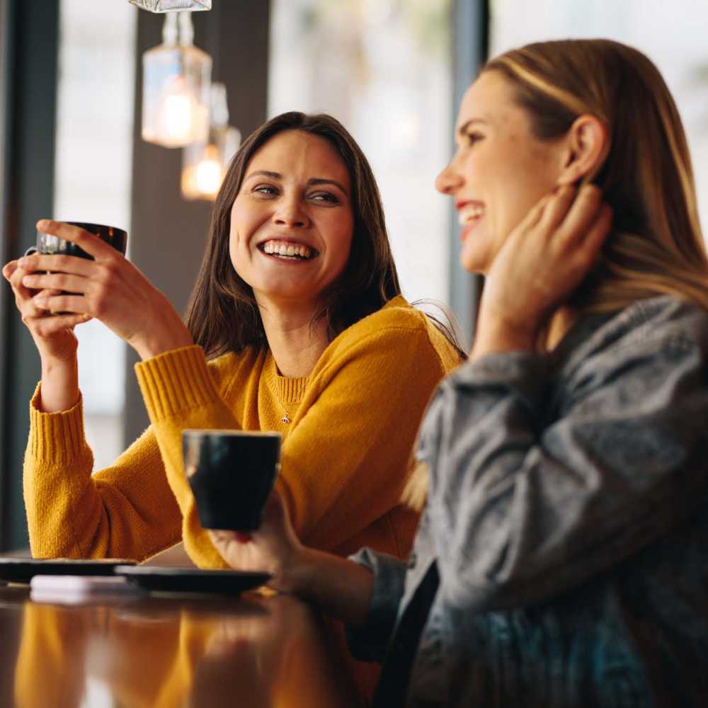 Residents sipping coffee at a cafe near Los Flamboyanes in Rochester, New York