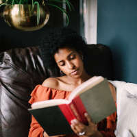 Resident reading a book at Tapestry on Vaughn in Montgomery, Alabama,