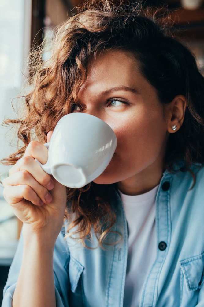 Woman drinking coffee near Flats On Wakefield in San Antonio, Texas