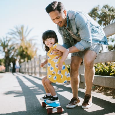 A resident teaching his daughter to skateboard at Seal Beach Officer Housing in Seal Beach, California