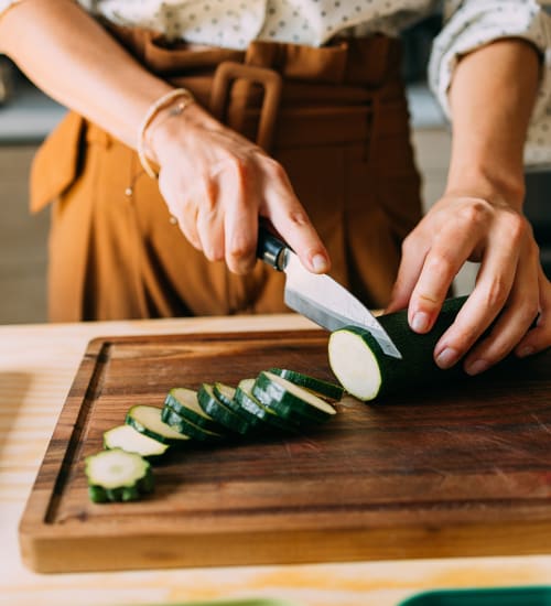 Woman chopping vegetables at Silo Creek Apartments in Lafayette, Louisiana