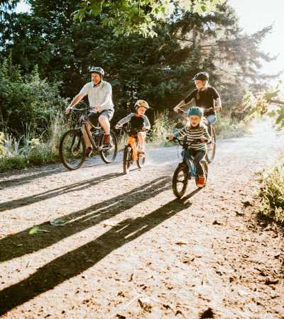 Family biking on a trail near Gateway Plaza Apartments in Portland, Oregon