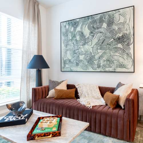 Cozy living room with a couch and wall painting at Terrazzo in Durham, North Carolina
