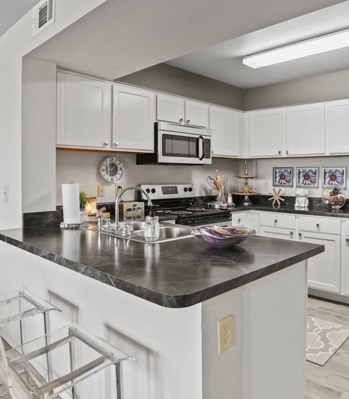 Kitchen with granite countertops at Cottages at Abbey Glen Apartments in Lubbock, Texas
