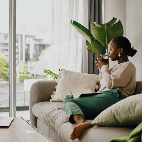 A resident sips coffee in her apartment at Promenade Pointe, Norfolk, Virginia