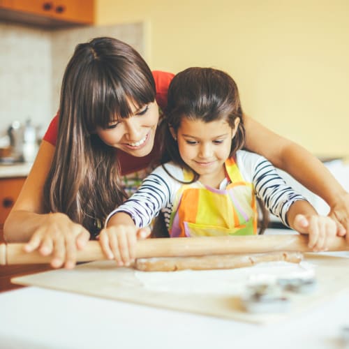 A mother and her daughter baking in a home at South Mesa II in Oceanside, California