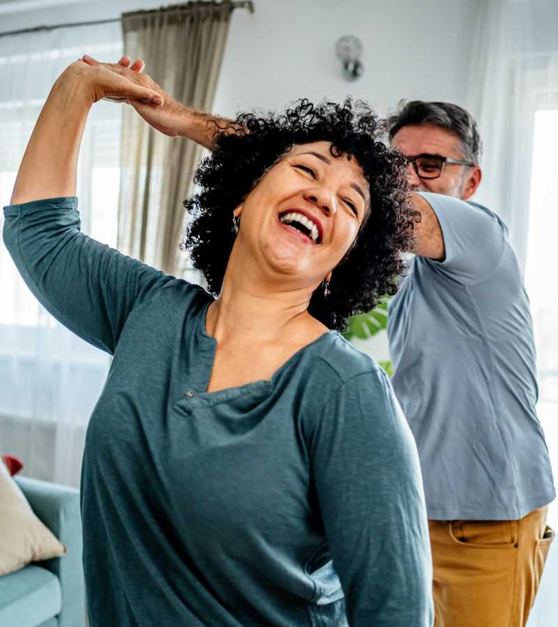 Happy couple dancing indoors and smiling at Eagle Ridge Circle in Rochester, New York
