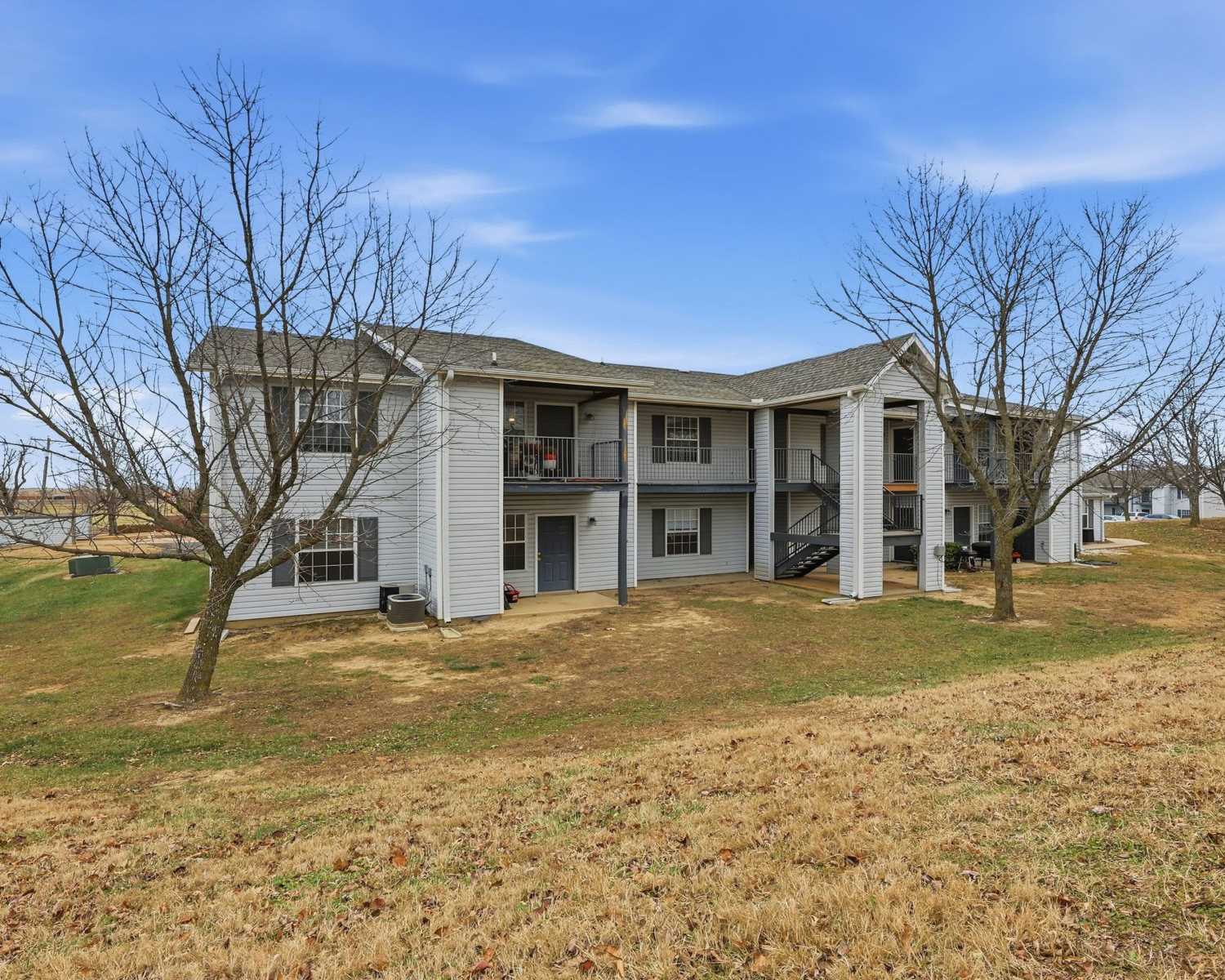 Exterior of the apartment building in with grassy lanscape at Parkford Apartments in Iola, Kansas