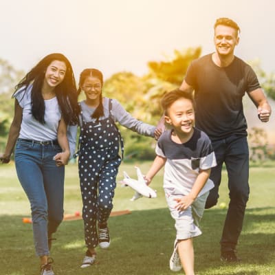 A family playing in a park near Discovery Village in Joint Base Lewis McChord, Washington