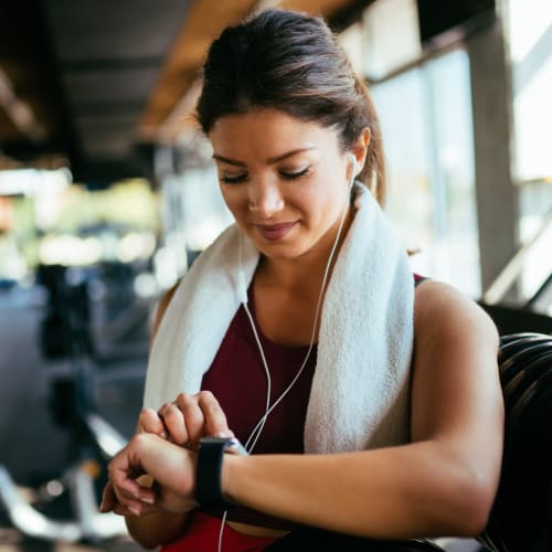 A woman checking her pulse after working out at Gela Point in Virginia Beach, Virginia