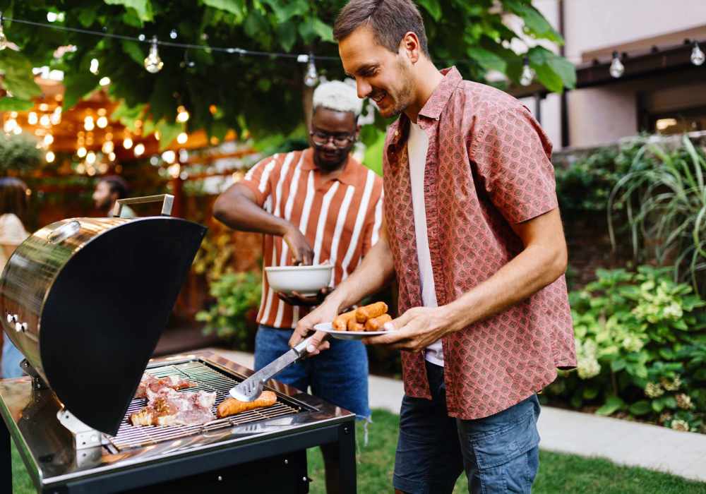 Residents cooking food on the BBQ grill at Athena Garden Apartments in Athens, Texas