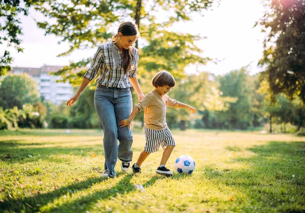 Resident mother playing with her kid in a park at Cabrillo Apartments in Scottsdale, Arizona 