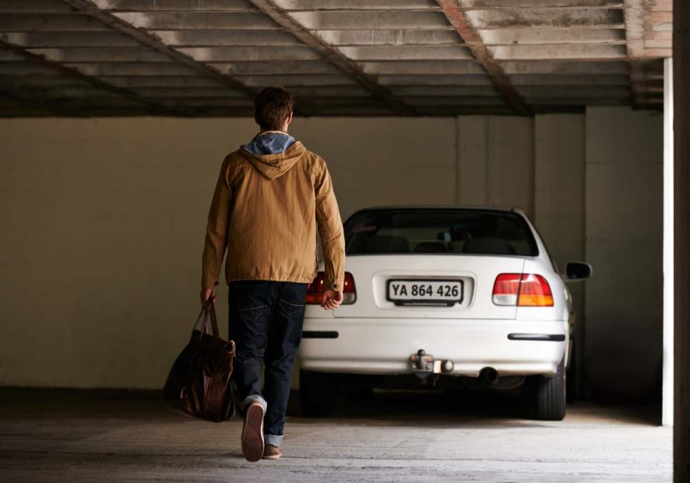 Resident walking towards his car in a carport parking at Copper Hill in Spokane, Washington