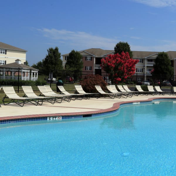 Chaise lounge chairs around the pool at Mill Pond Village Apartments in Salisbury, Maryland
