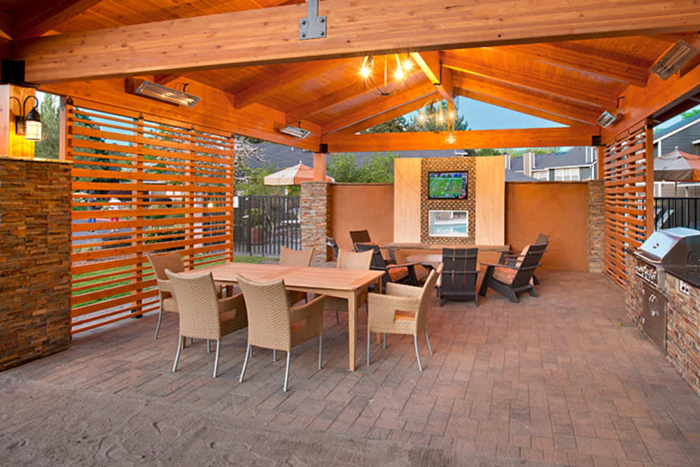 Covered lounge seating by the pool at Slate Ridge at Fisher's Landing Apartment Homes in Vancouver, Washington