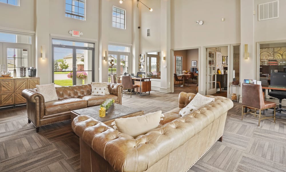 Lounge area with leather couches  at The Remington Apartments in Wichita, Kansas