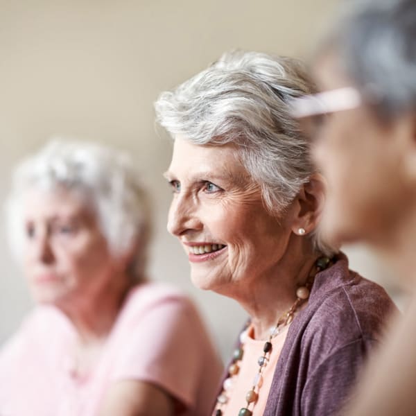 A resident listening to a talk at Pacifica Senior Living Sterling in Sterling, Virginia.