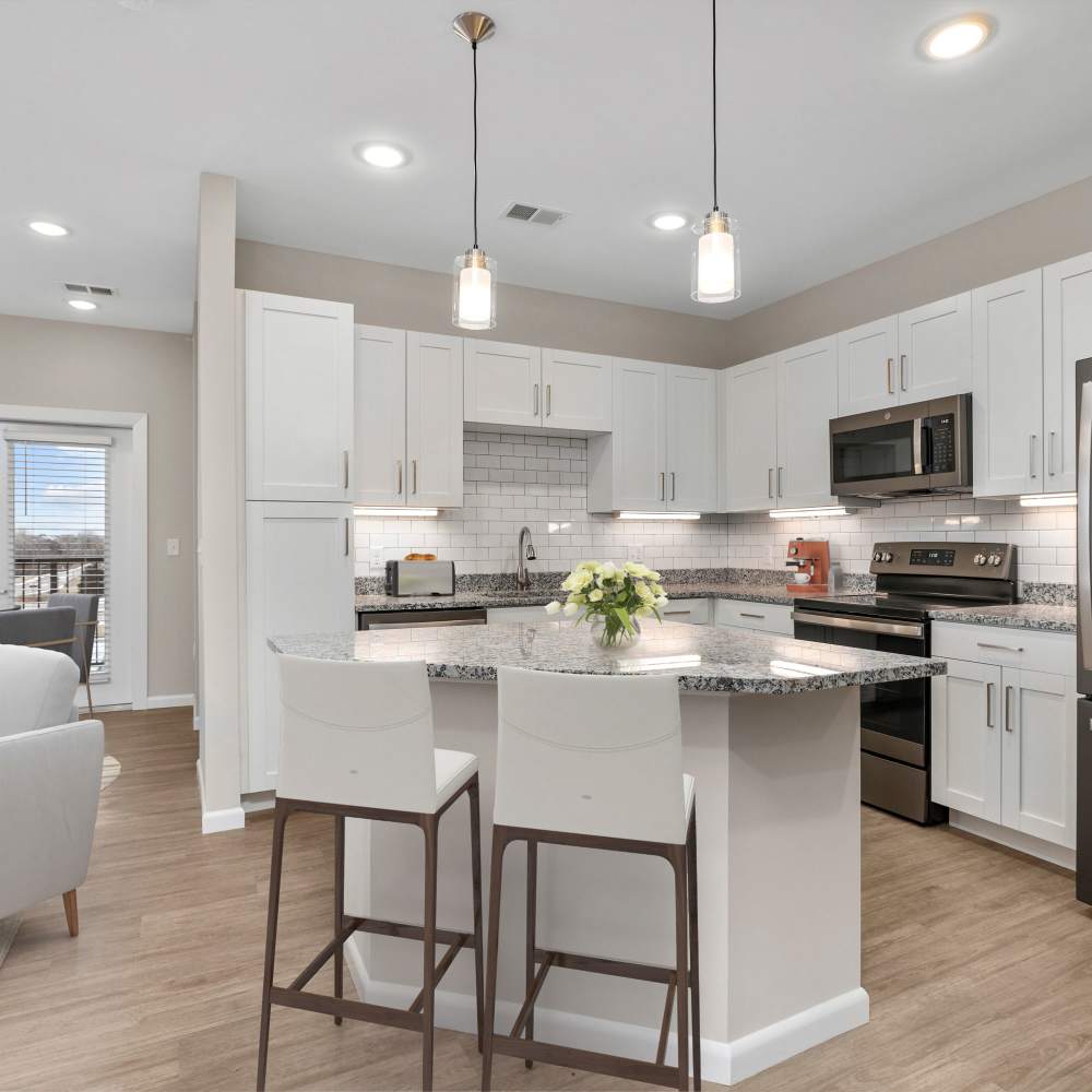 Kitchen with wooden cabinets and granite countertops at Citrine at Lake St. Louis in Lake Saint Louis, Missouri