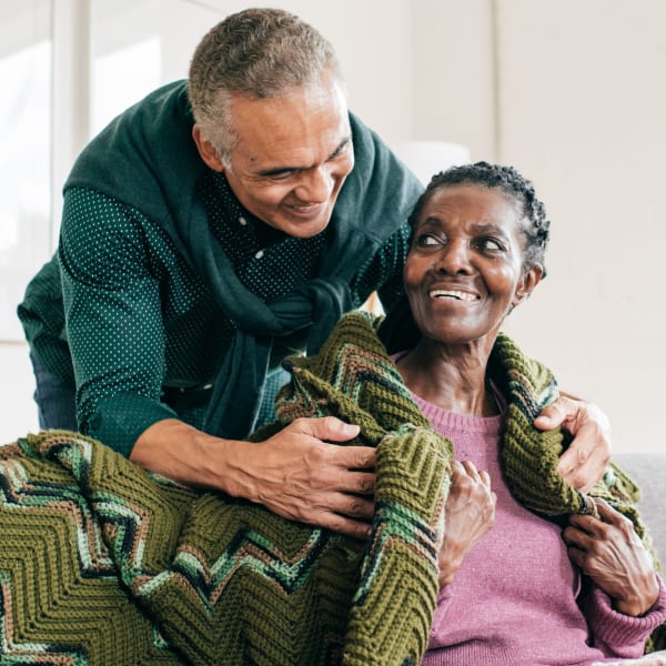 Resident being embraced from behind at Avila Senior Living at Downtown SLO in San Luis Obispo, California