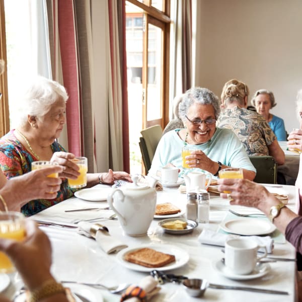A group of residents enjoying a meal together at The Princeton Senior Living in Lee's Summit, Missouri
