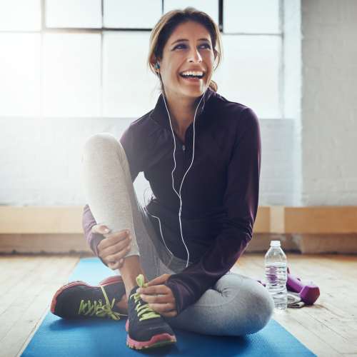 Resident practicing yoga in the gym at Pacific Landing in Murrieta, California