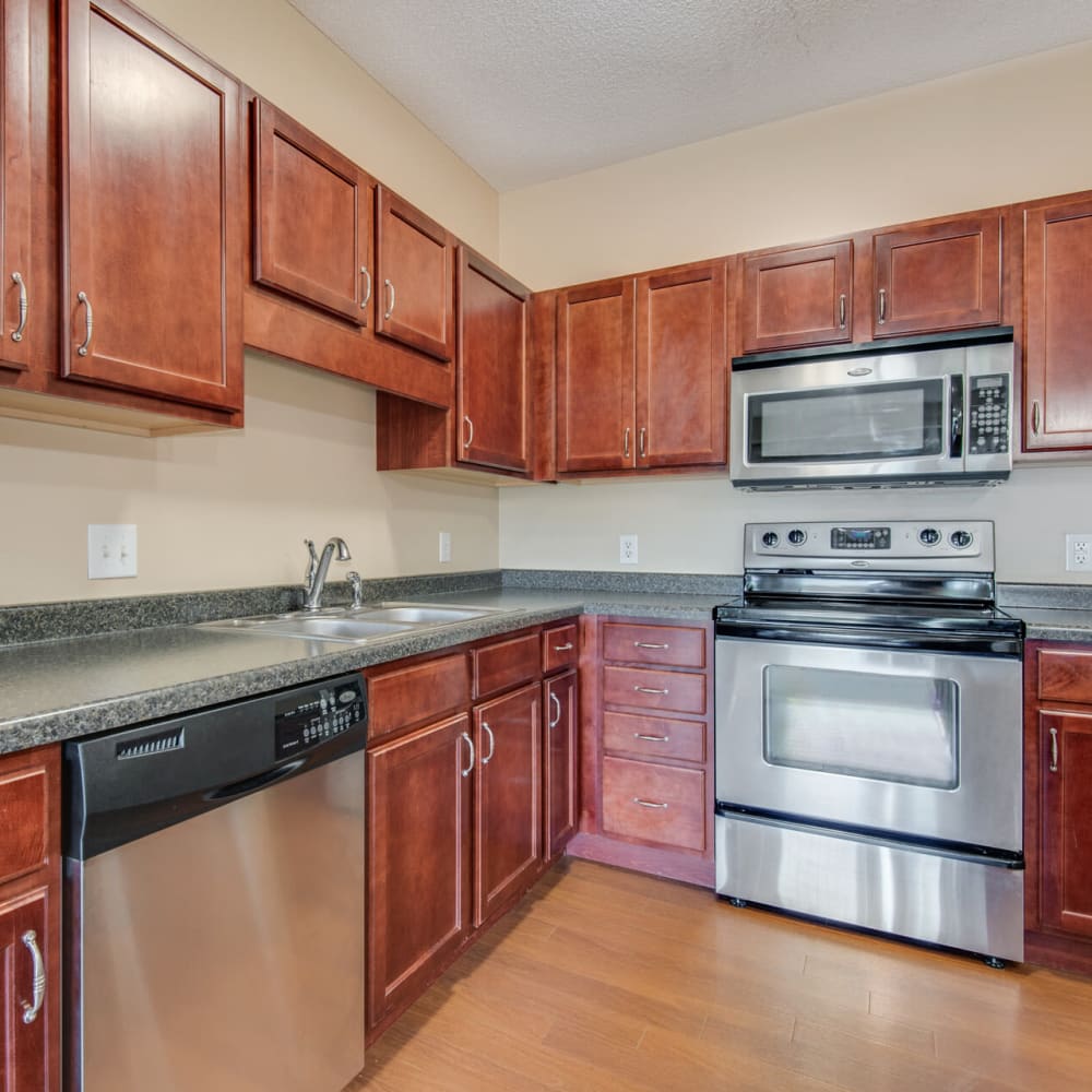 Cherry wood cabinetry and granite countertops in a model home's kitchen at Oaks Glen Lake in Minnetonka, Minnesota