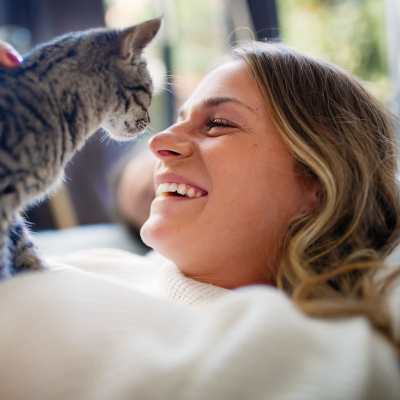 Resident playing with her cat at The Enclave at Bear Creek in Euless, Texas