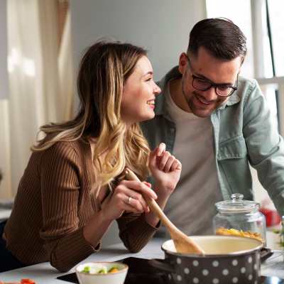 Residents cooking food in the kitchen at The Tuscany On Pleasant View in Madison, Wisconsin
