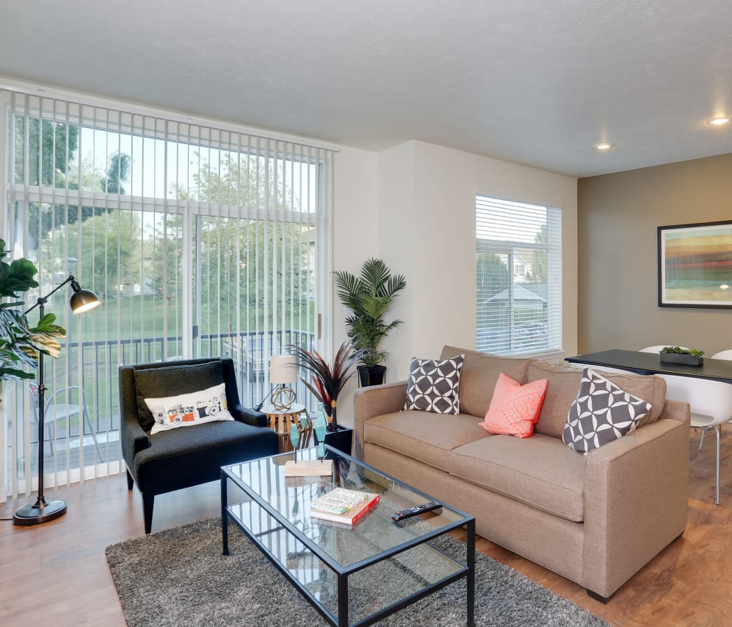 Living room and dining area in open-concept floor plan of model home at Big Trout Lodge in Liberty Lake, WA